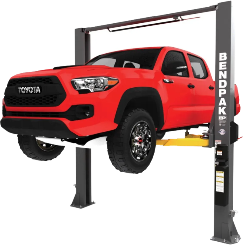 Pickup truck raised on a two-post lift